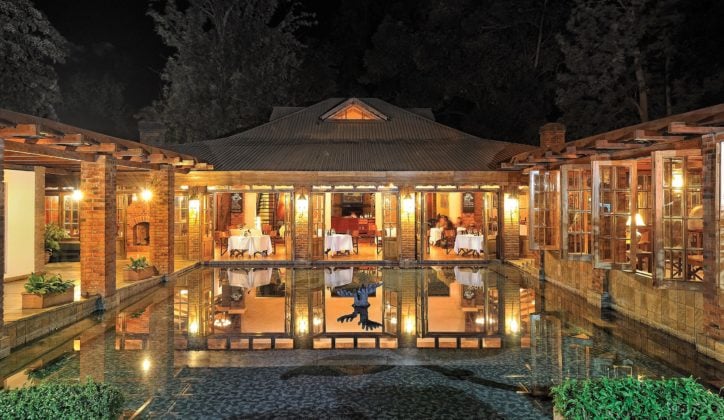 View of the dining room of Arusha Coffee Lodge from across the fountain at night, Arusha Tanzania