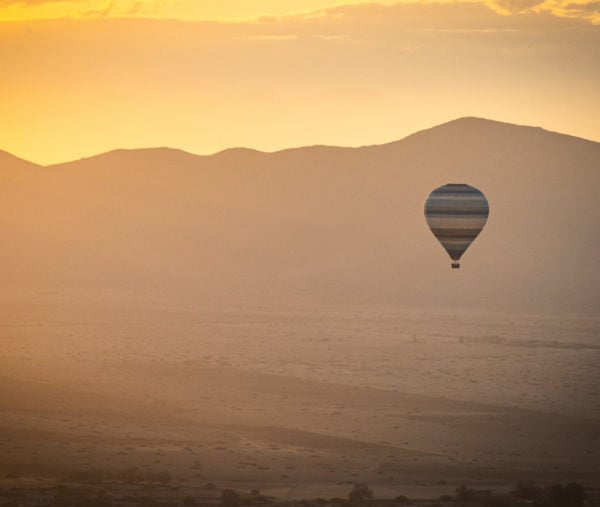 Hot air balloon over Marrakech in the sunset light.