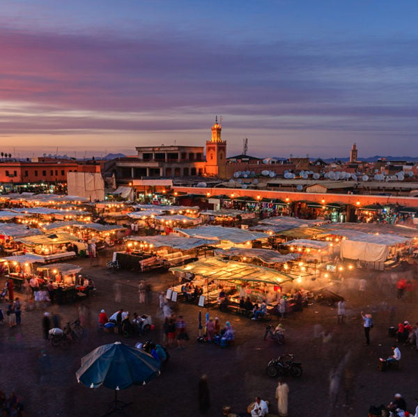 Marrakech outdoor souk with tented stalls at sunset