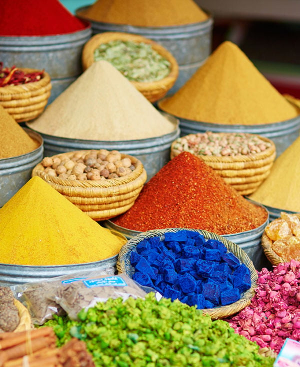 Selection of pyramids of brightly coloured spices on a Moroccan market