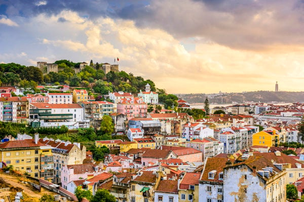 View of colourful buildings with red roofs on a hillside in Lisbon, Portugal