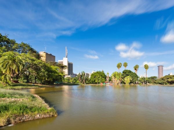 Long exposure of the skyline of Nairobi, Kenya with the beautiful lake in Uhuru Park in the foreground and some blurred boats.