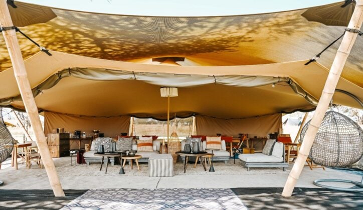 Open lounge of luxury safari camp Wilderness Usawa with sunlight and sofas, Serengeti National Park Tanzania