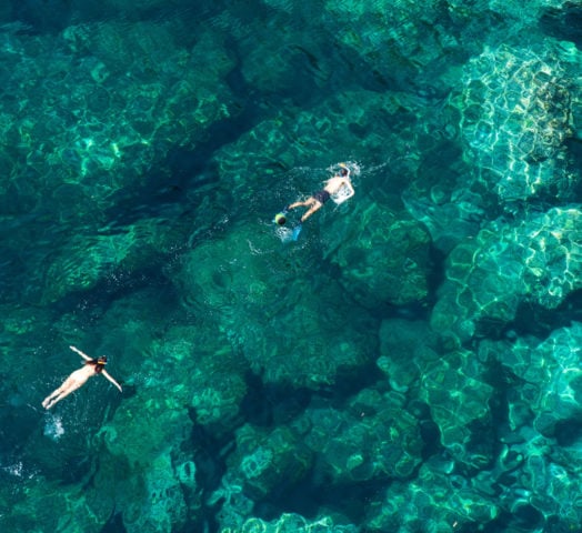 Couple snorkelling in the clear turquoise waters of Zanzibar, Tanzania